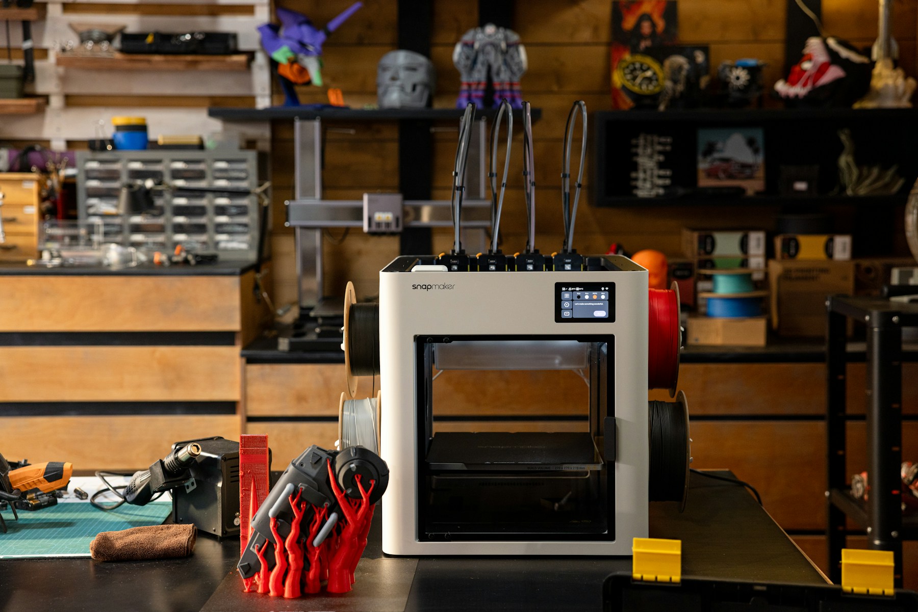 3D printer workshop with filament and prototype parts